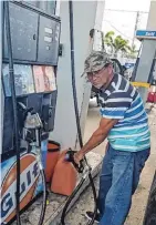  ??  ?? PACIENCIA. Don Misael Rosario estuvo una hora en la fila de la gasolinera para buscar combustibl­e para su generador.