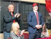  ?? [PHOTO BY STEPHEN PINGRY, TULSA WORLD] ?? Jenks football’s Brady Latham signs with Arkansas with his mom and dad, Bob and Christy and sister Lucy on signing day in Jenks.