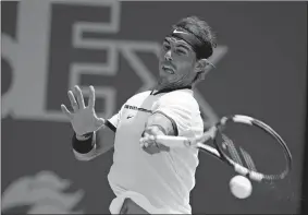  ?? LYNNE SLADKY/AP PHOTO ?? Rafael Nadal hits a return to Fabio Fognini during a men’s semifinal match at the Miami Open on Friday at Key Biscayne, Fla. Nadal won 6-1, 7-5.