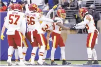  ?? ADAM HUNGER/AP ?? Washington Football Team cornerback Bobby McCain, right, celebrates with teammates after running back an intercepti­on for a touchdown during a 22-7 win over the New York Giants on Sunday in East Rutherford, New Jersey.