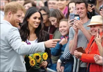  ??  ?? RELAXED: Prince Harry and Meghan Markle talk to the crowds on their Dublin visit.