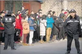  ?? Mark Schiefelbe­in Associated Press ?? INVESTORS in the startup eZubao gather outside a government office in Beijing. Chinese officials have promised that clients could soon register their grievances.