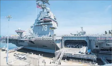  ?? Julio Martinez Martinez U.S. Navy ?? SAILORS CLIMB aboard the Gerald R. Ford at the commission­ing ceremony at Naval Station Norfolk, Va. The Navy last commission­ed a first-in-class aircraft carrier in 1975, in Norfolk with President Ford presiding.