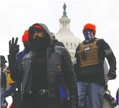  ?? JIM urquhart / REUTERS ?? Supporters of former president Donald Trump flash white power signs during their Jan. 6 assault on the Capitol.