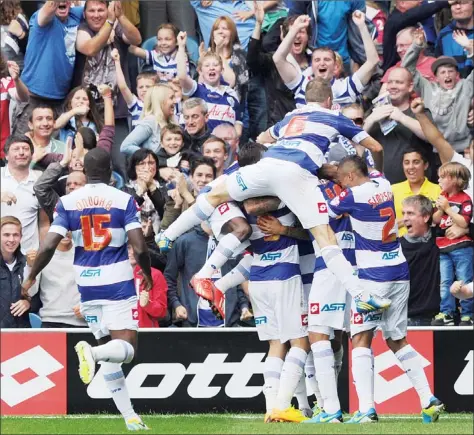  ?? PICTURES: Action Images ?? HAPPY CHAPS: QPR’s Tom Hitchcock is mobbed by teammates after scoring the late winner