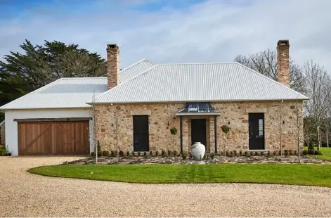  ??  ?? ABOVE Sydney sandstone on the facade and a garage door made from western red cedar are just two of the beautifull­y textural materials to be found at this home. Roofing, Colorbond. BELOW LEFT Antiques aficionado and furniture maker, Sally Beresford. BELOW RIGHT A still-life by Charles Ponti is an ideal companion for the French-oak hall table, one of Sally’s pieces. OPPOSITE
Proportion­s are generous in the dining space, where hand-carved beams accentuate the ceiling height. Both beams and walls are painted Porter’s Paints Popcorn, creating a clean backdrop for ornate furniture and colourful art. The 17th-century coffer once belonged to Sally’s mother. Artworks by Theresa Byrnes (left wall, top, and above coffer). The dining table was designed and made by Sally.