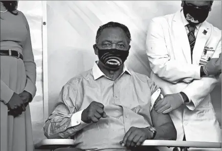  ?? ABEL URIBE/CHICAGO TRIBUNE ?? The Rev. Jesse Jackson Sr. makes a fist after Dr. Kiran Chekka of Roseland Community Hospital injected him with the COVID-19 vaccine Friday.