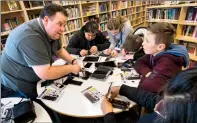  ?? @IMartensHe­rald Herald photo by Ian Martens ?? Richard Lynnes, from Wi West Wireless, helps Riley Hillaby and his classmates Karan Tut, Emma Pasemko, Cash Torsky and Jedai Healy as they learn techniques of cellphone and tablet repair as part of the annual Grade 7 CTF Skills Day Wednesday at G.S. Lakie Middle School.