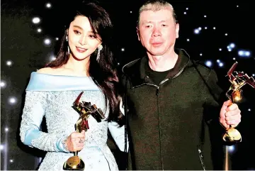  ??  ?? Feng, with actress Fan Bingbing posing with their Best Actress and Best Film awards at the Asian Film Awards in Hong Kong last March. — Reuters photo