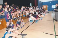  ??  ?? Director of basketball Andrew Taylor talks to students.