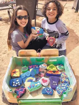  ?? COURTESY OF JENNIFER COUTURE ?? Madison Couture, 11, and Benjamin Couture, 8, of Santa Fe spent time painting rocks to randomly place on doorsteps of the people in their neighborho­od to bring them joy during this time. They called it “Operation Joyful Art.” Their mother, Jennifer Couture, shared this photo of them and their work on Instagram and Facebook.