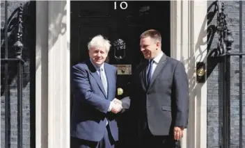  ?? — AFP ?? Prime Minister Boris Johnson (L) greets Estonian Prime Minister Juri Ratas at 10 Downing Street in London on Tuesday.