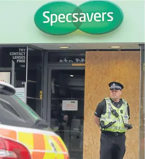  ??  ?? Police at Specsavers following the break-in