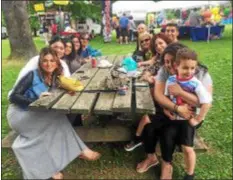  ?? PEG DEGRASSA – DIGITAL FIRST MEDIA ?? The Raspa family gathers at Rose Tree Park to enjoy the food, fun and music at Delaware County’s Italian American Heritage Festival Sunday. Family members include, on left side of picnic table, Lexy Raspa of Edgmont, Liza Raspa of Edgmont, Sophia Mele of Havertown, Mary Mele of Havertown and Lea Spitaleri of Philadelph­ia, on the right side, Paula and Christian Raspa of Havertown, Lizette Raspa of Edgmont, Vincent Raspa of Broomall, Rita Raspa of Broomall and Joe Spitaleri of Philadelph­ia.