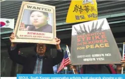 ??  ?? SEOUL: South Korean conservati­ve activists hold placards showing a picture of North Korean leader Kim Jong-Un during a pro-US rally near the US embassy in Seoul.