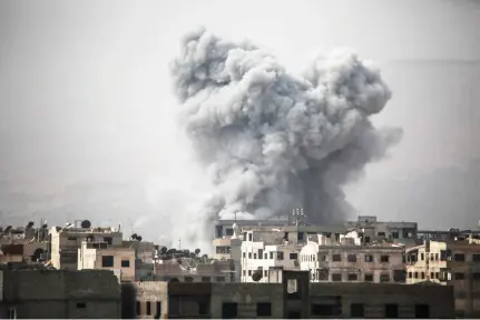  ??  ?? Smoke billows from buildings following a reported air strike on Ain Tarma in the Eastern Ghouta area, an opposition stronghold east of Damascus, on Monday. (AFP)