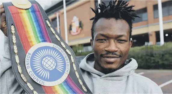  ??  ?? Thomas Essomba proudly displays the Commonweal­th belt he will defend in London on Friday night. Picture: Frank Reid