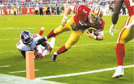  ?? Thearon W. Henderson / Getty Images ?? Quarterbac­k C.J. Beathard dives into the end zone at the end of an 11-yard TD run on the first play of the fourth quarter.