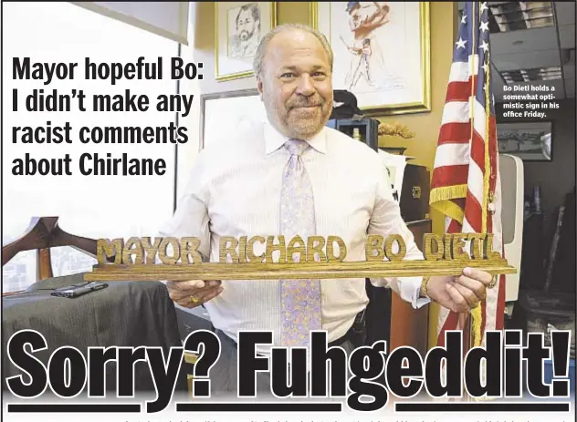  ??  ?? Bo Dietl holds a somewhat optimistic sign in his office Friday.