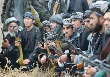  ?? — AFP ?? This file photo taken on October 18, 2015 shows anti-Taliban armed Afghan fighters listening to their commander during a patrol against Taliban insurgents at Jamshedi, on the outskirts of northern Faryab province.