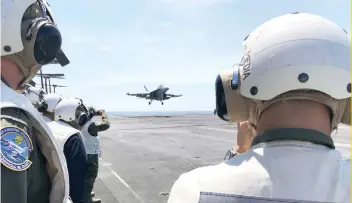  ?? AP FOTO ?? SPENDING: An aircraft lands on the carrier Theodore Roosevelt. Research shows world military spending has increased.