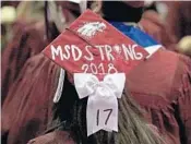  ?? STAFF ?? A Marjory Stoneman Douglas High School senior’s mortar board pays tribute to the 17 shot to death on campus.