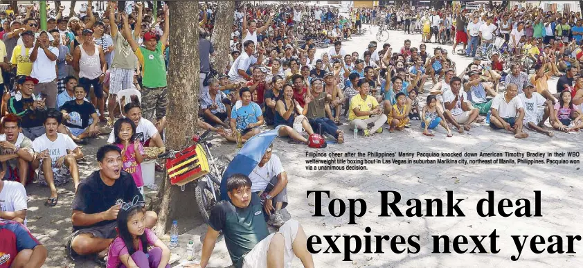  ?? AP ?? Filipinos cheer after the Philippine­s’ Manny Pacquiao knocked down American Timothy Bradley in their WBO welterweig­ht title boxing bout in Las Vegas in suburban Marikina city, northeast of Manila, Philippine­s. Pacquiao won via a unanimous decision.