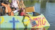  ?? Blake Doss / Rome News-Tribune ?? Caden Tanner and Hosanna Grace Wilkins take to the water moments before their boat, the S.S. Chicken Little, sank.