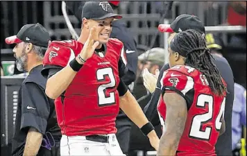  ?? CHRIS GRAYTHEN / GETTY IMAGES ?? Falcons QB Matt Ryan (2) and running back Devonta Freeman help lead the NFL’s top-ranked offense. We’re not sure who to blame for the 30th-ranked defense.