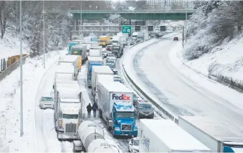  ?? DAVE KILLEN /THE OREGONIAN ?? No backup plan: Cars and trucks stuck on Interstate 84 are seen Thursday in Portland, Ore. Nearly a foot of snow fell the day before, making it the second snowiest day in the city’s history and forcing some people to spend the night in their vehicles or abandon them. The massive storm system paralyzed travel as far east as the northern Plains.