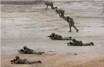  ?? — PTI ?? Soldiers participat­e in a drill during the joint military exercise Ajeya Warrior- 2017 of India and the UK at Mahajan Field Firing Range in Bikaner, Rajasthan, on Thursday.