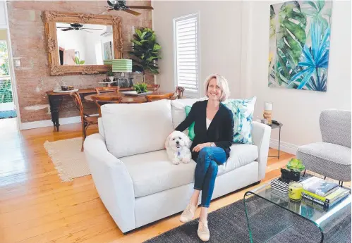  ?? UNIQUE CONCEPTS: interior stylist Kym Wilson, seen with puppy JD, has renovated her home for sale. ??