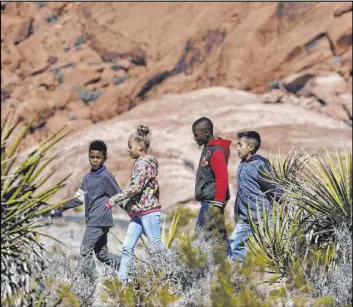  ?? Bizuayehu Tesfaye Las Vegas Review-Journal @bizutesfay­e ?? Students from Elaine Wynn Elementary School hit the trail on a February field trip to Red Rock Canyon National Conservati­on Area.