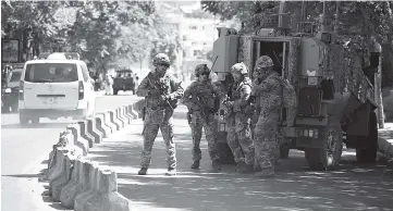  ?? — AFP photo ?? File photo of US soldiers standing guard near the site of a car bomb in the Afghan capital Kabul.Trump has granted the Pentagon authority to set troop levels in Afghanista­n, a US official said, a move that could lead to the deployment of thousands more...