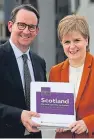  ??  ?? First Minister Nicola Sturgeon receives the Sustainabl­e Growth Commission report from commission chairman Andrew Wilson.