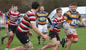  ??  ?? Enniscorth­y’s Arthur Dunne delivers a pass in the win at home to Monkstown on Saturday.