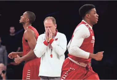  ?? ASSOCIATED PRESS ?? Wisconsin coach Greg Gard gets his players ready Thursday for the Badgers’ game against Florida on Friday.
