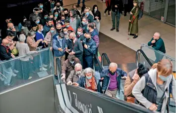  ?? — AFP ?? Patients arrive to receive a dose of a Covid-19 vaccine at a vaccinatio­n centre in a shopping mall of Belgrade on Thursday. Serbia’s president said that his country would pay each citizen who gets a Covid jab before the end of May, in what could be the world’s first cash-for-jabs scheme.