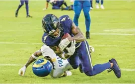  ?? JERRY JACKSON/STAFF ?? Ravens wide receiver Zay Flowers scores a touchdown late in the fourth quarter Sunday against the Rams.