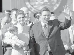  ?? LYNNE SLADKY/AP ?? Gov. Ron DeSantis waves during an inaugurati­on ceremony with his wife, Casey, and son Mason on Tuesday in Tallahasse­e.