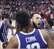  ?? CHASE SEABOLT — THE ASSOCIATED PRESS ?? TCU’s Xavier Cork (12) and JaKobe Coles (21) celebrate a win over Texas Tech after an NCAA college basketball game on Saturday.