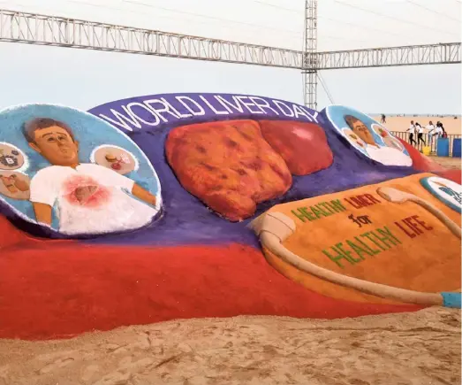  ?? THE HINDU ?? A sand sculpture to promote a ‘Healthy Liver for Healthy Life’ created by artist Sudarshan Pattnaik at Marina beach in Chennai.