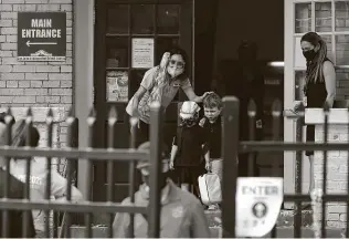  ?? Photos by Jerry Lara / Staff photograph­er ?? Children are released at the end of the school day at San Antonio ISD’s Advanced Learning Academy. As pandemic metrics improve, schools have more latitude on reopening.