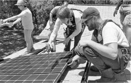  ?? STEVEN LEMONGELLO/STAFF ?? Democratic gubernator­ial candidate Gwen Graham installs solar panels near Bithlo on one of her campaign’s “workdays,” made famous by her father, former Florida Gov. Bob Graham. “We need Florida to be the solar capital of the world,” she said.