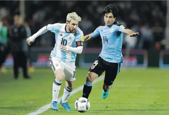  ?? THE ASSOCIATED PRESS ?? Uruguay’s Nicolas Lodeiro, right, challengin­g Argentina’s Lionel Messi at a World Cup qualifying match Sept. 1, will play for Seattle against the Caps Saturday.
