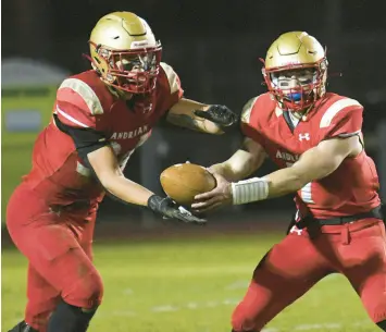  ?? KYLE TELECHAN/POST-TRIBUNE ?? Andrean quarterbac­k Billy Henry, right, hands the ball to Drayk Bowen during a Class 2A regional championsh­ip game against Lafayette Central Catholic on Friday.