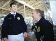  ??  ?? Lodi High FFA’s Trevor Jackson, 17 talks to Fatum Kell, 17, about his entry during the rabbit judging portion during the San Joaquin AgFest 2019 at the San Joaquin County Fairground­s in Stockton on Thursday.