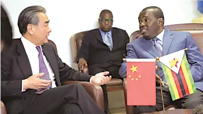  ?? — ?? Foreign Affairs and Internatio­nal Trade Minister Dr Sibusiso Moyo (right) welcomes Chinese Foreign Affairs Minister Mr Wang Yi at the Robert Gabriel Mugabe Internatio­nal Airport in Harare last night. Picture: Tawanda Mudimu