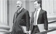  ?? Frank Franklin II / Associated Press ?? Ted Wells, left, the lead attorney for Exxon Mobil, leaves court with a colleague Thursday in New York.