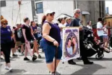  ?? ANNE NEBORAK – DIGITAL FIRST MEDIA ?? Young and old carried signs of loved ones, T-shirts with their pictures and names, and wore purple to make others aware of the price of drug use and the opioid epidemic.